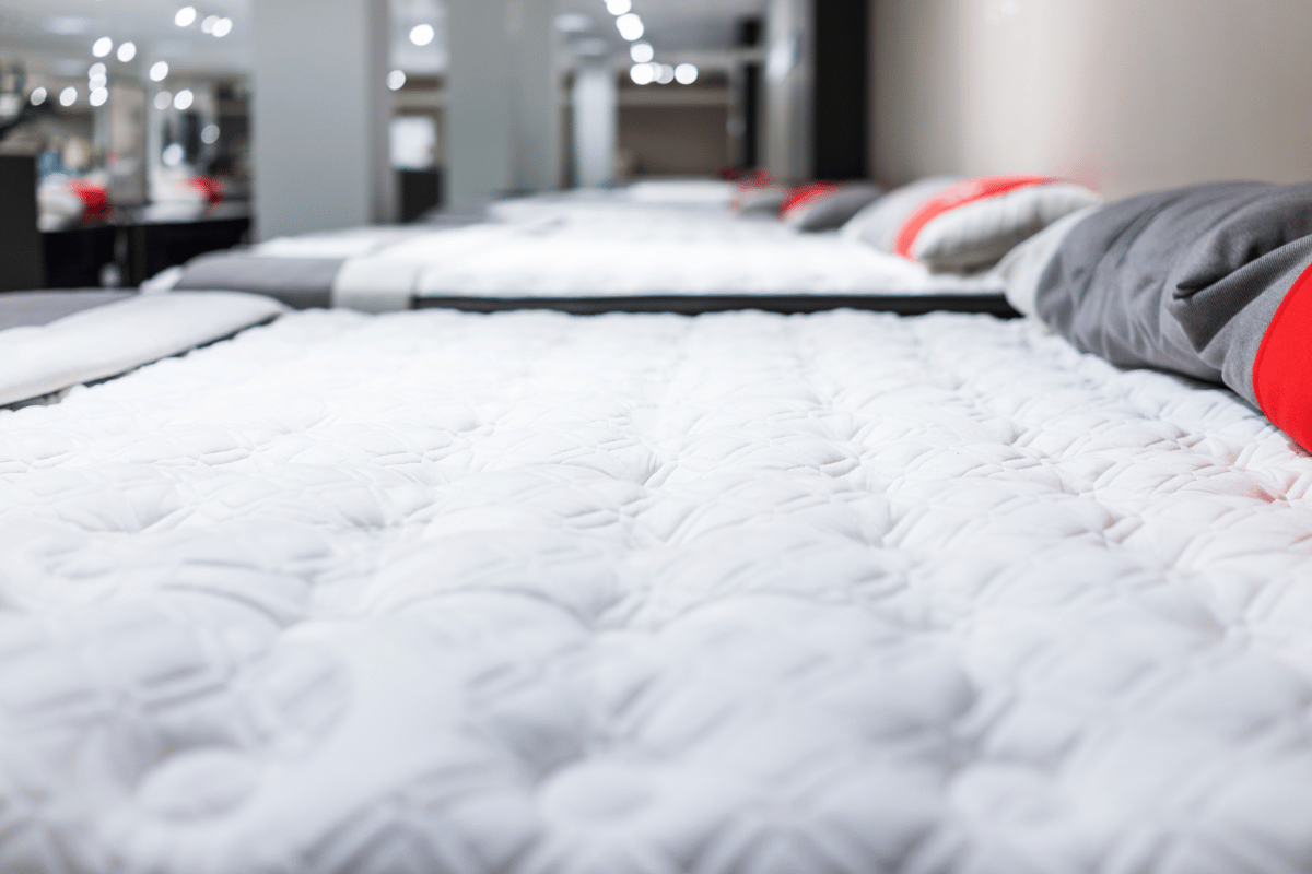 A line of different mattresses at a furniture store
