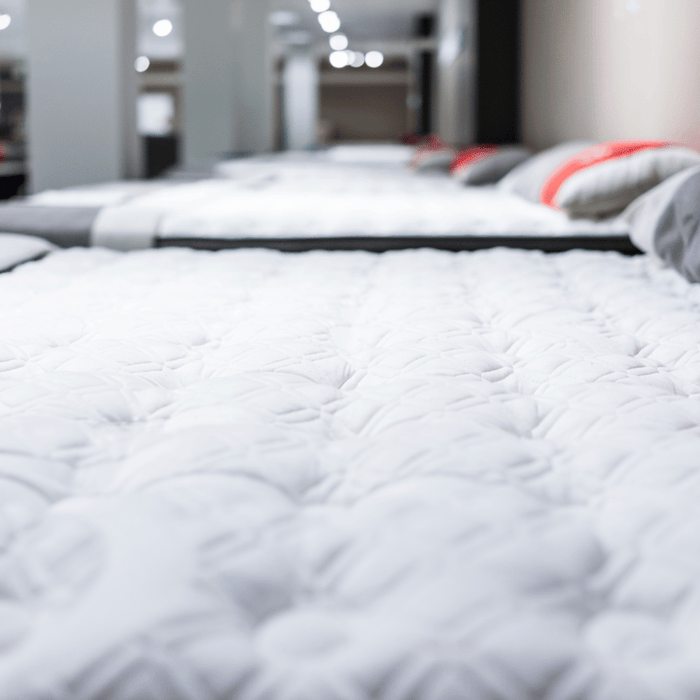 A line of different mattresses at a furniture store